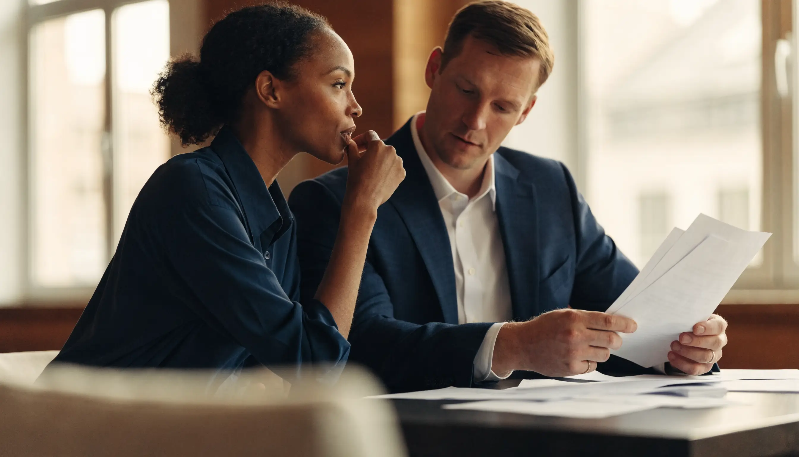 Two All American Tax advisors reviewing a client's return together